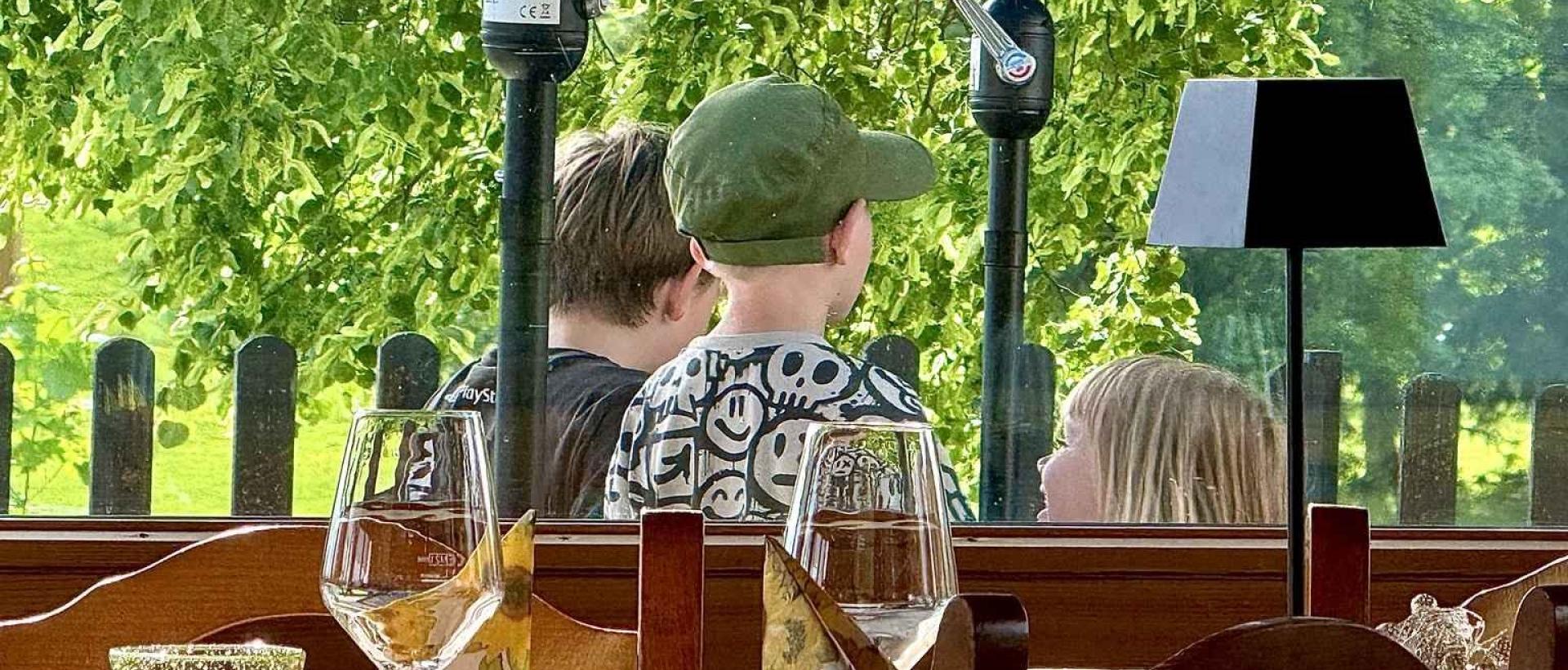 Famille profitant de la terrasse de l'Hôtel Restaurant Les Cernets au coeur du Val de Travers dans le Jura suisse